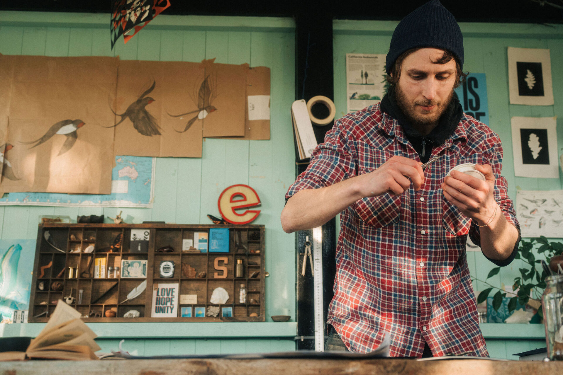 An artist cutting thread during an experiment with different threads and fishing line.
