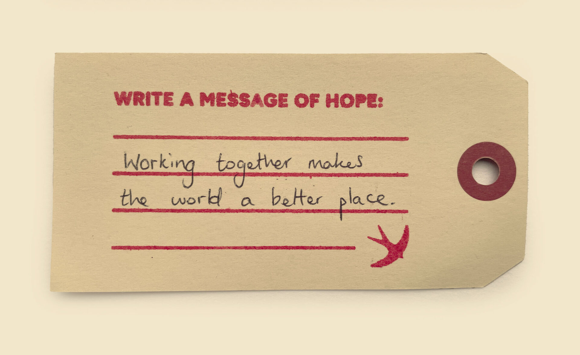 A photo of a luggage label with a handwritten message of hope