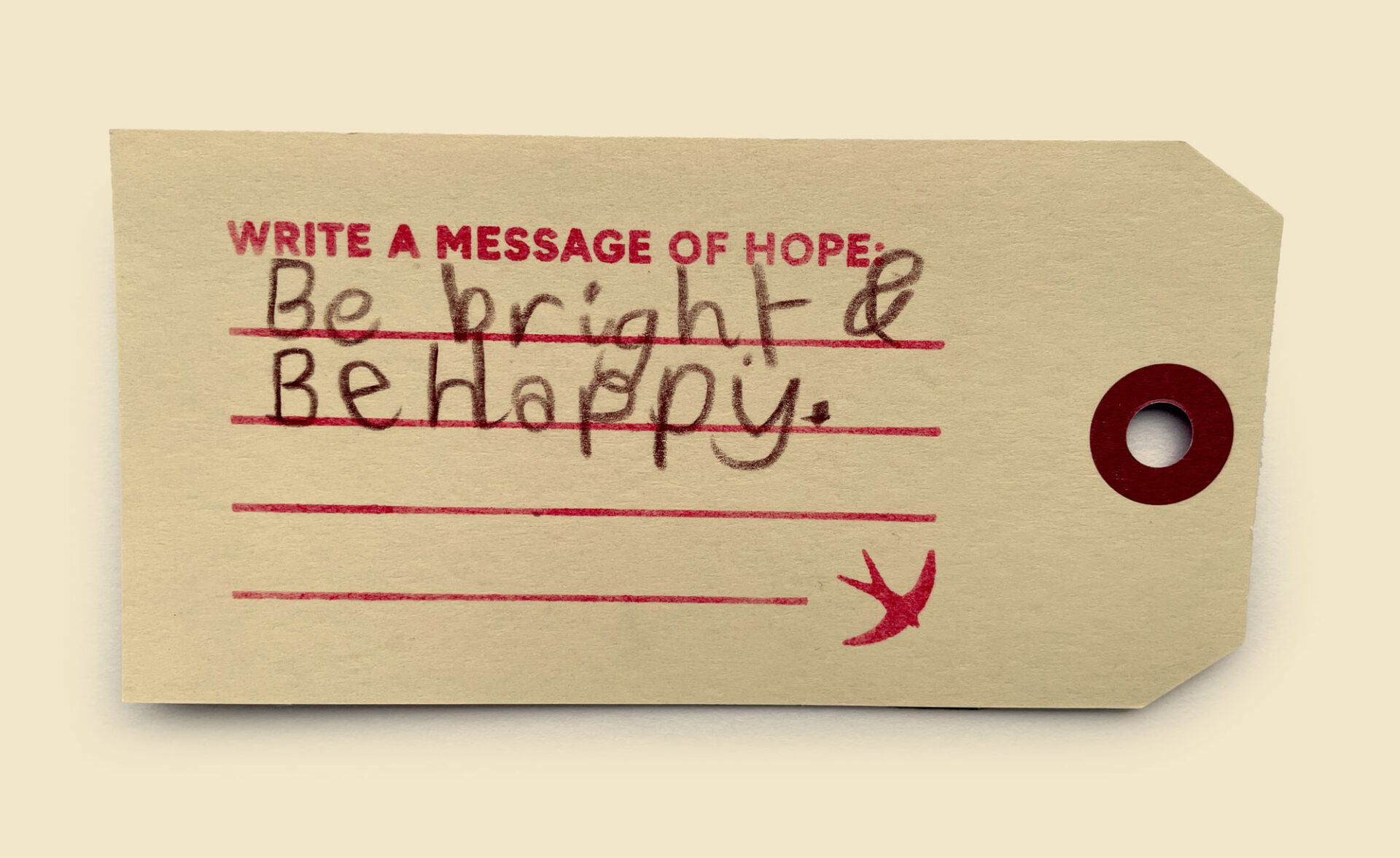 A photo of a luggage label with a handwritten message of hope