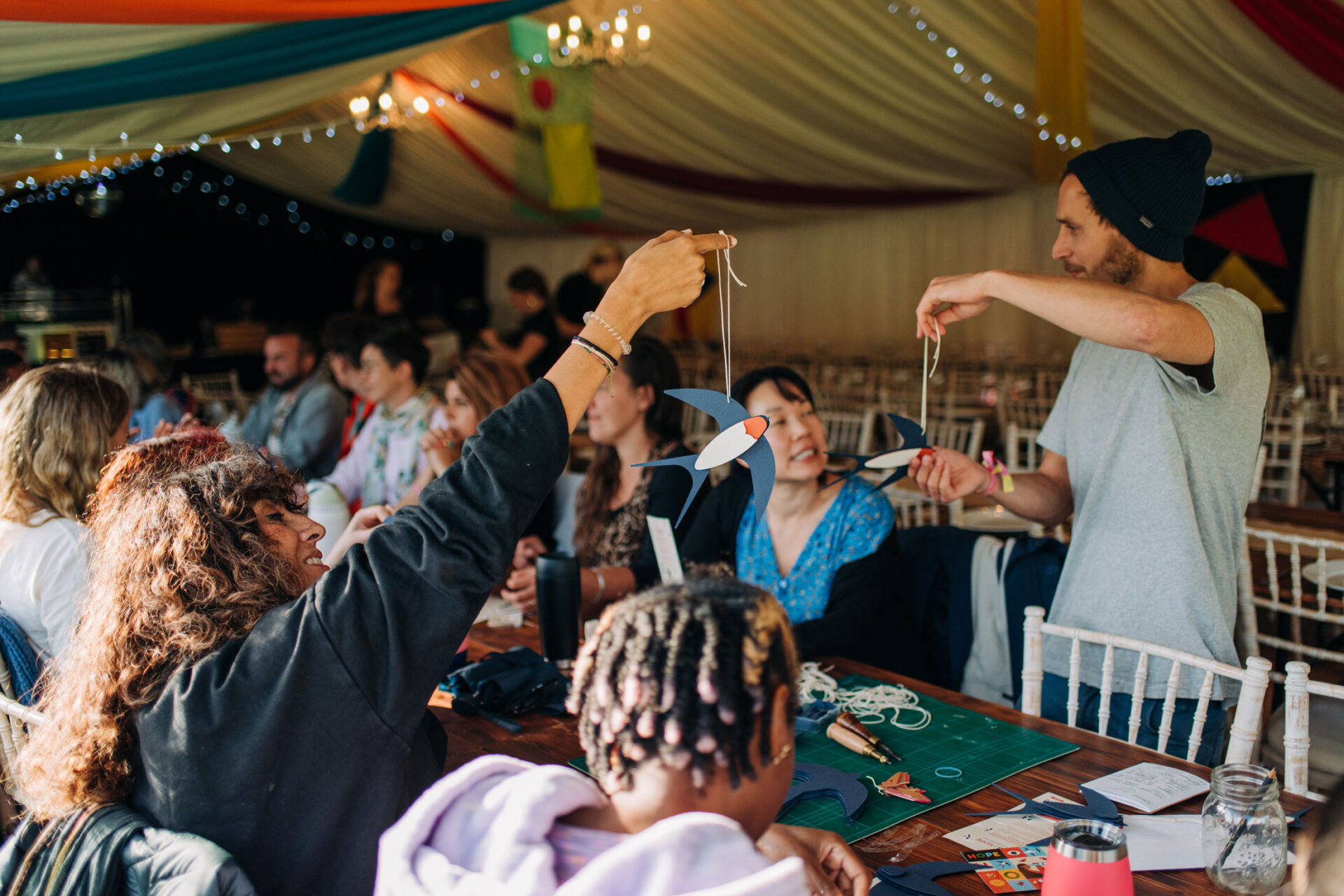 Artist Ed Harrison facilitates the crafting of barn swallows in a community workshop