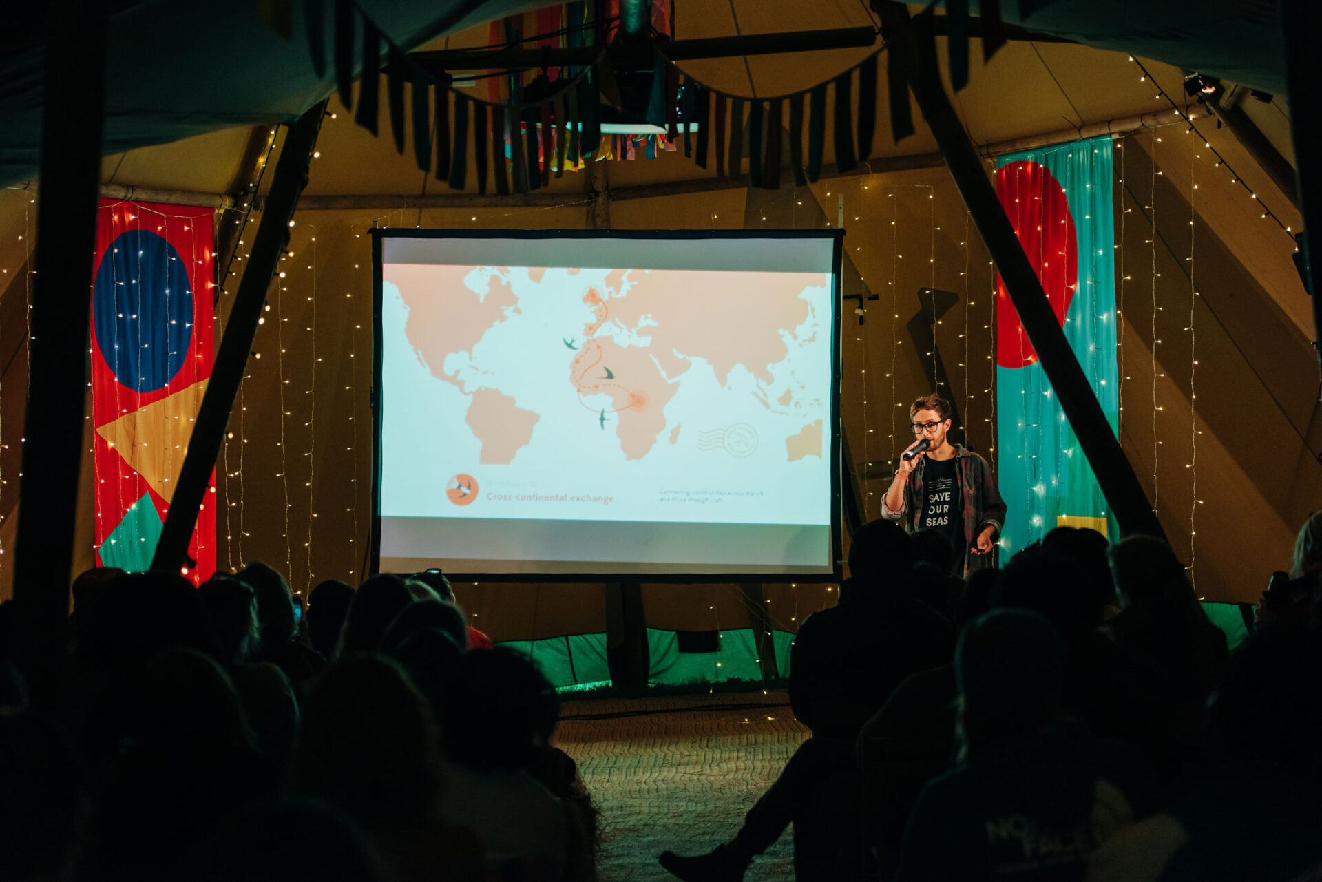 Artist Ed Harrison presenting a slide showing the migration route of barn swallows between the UK and Africa.