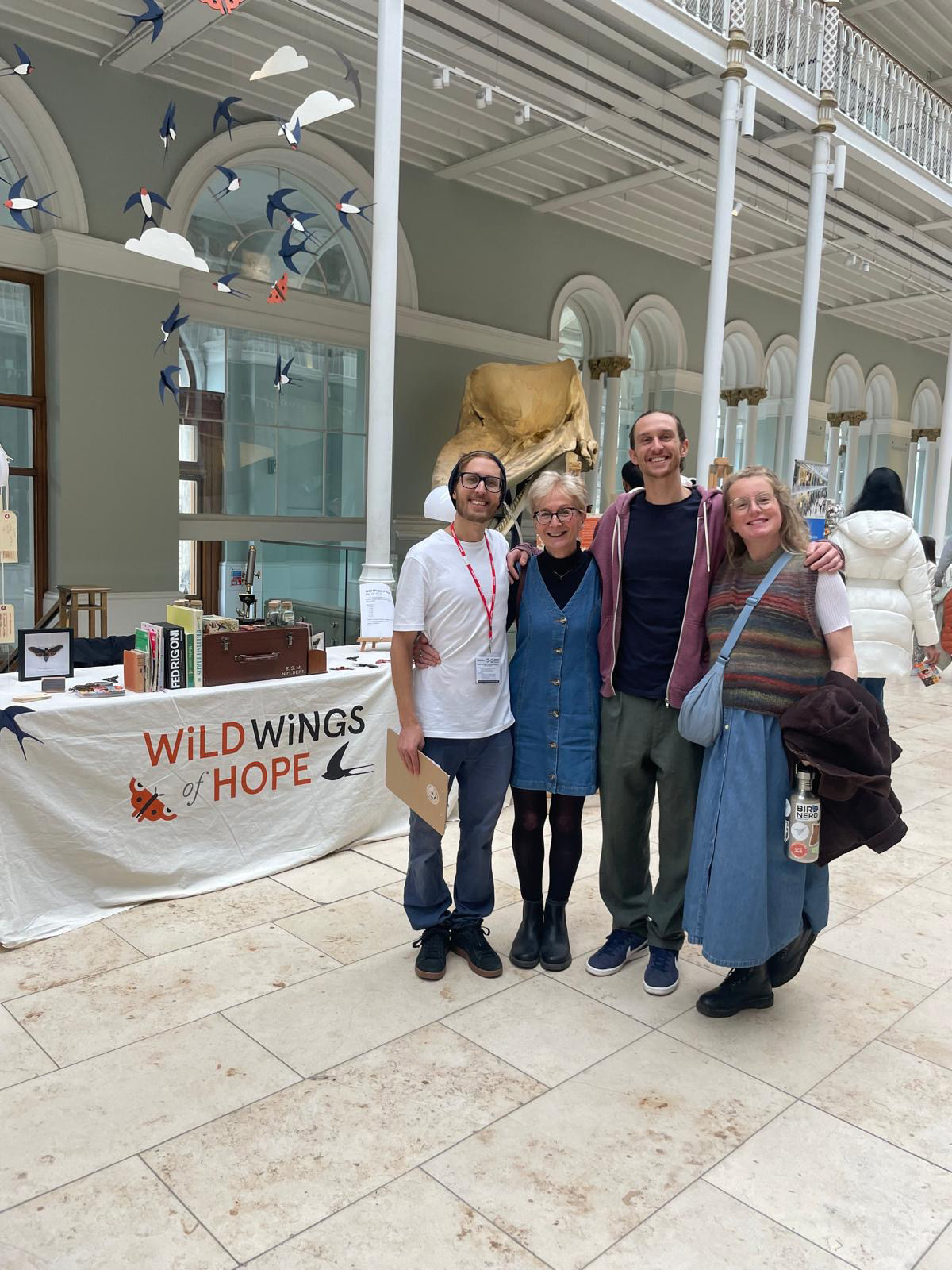The artist standing with family members inside the National Museum of Scotland.