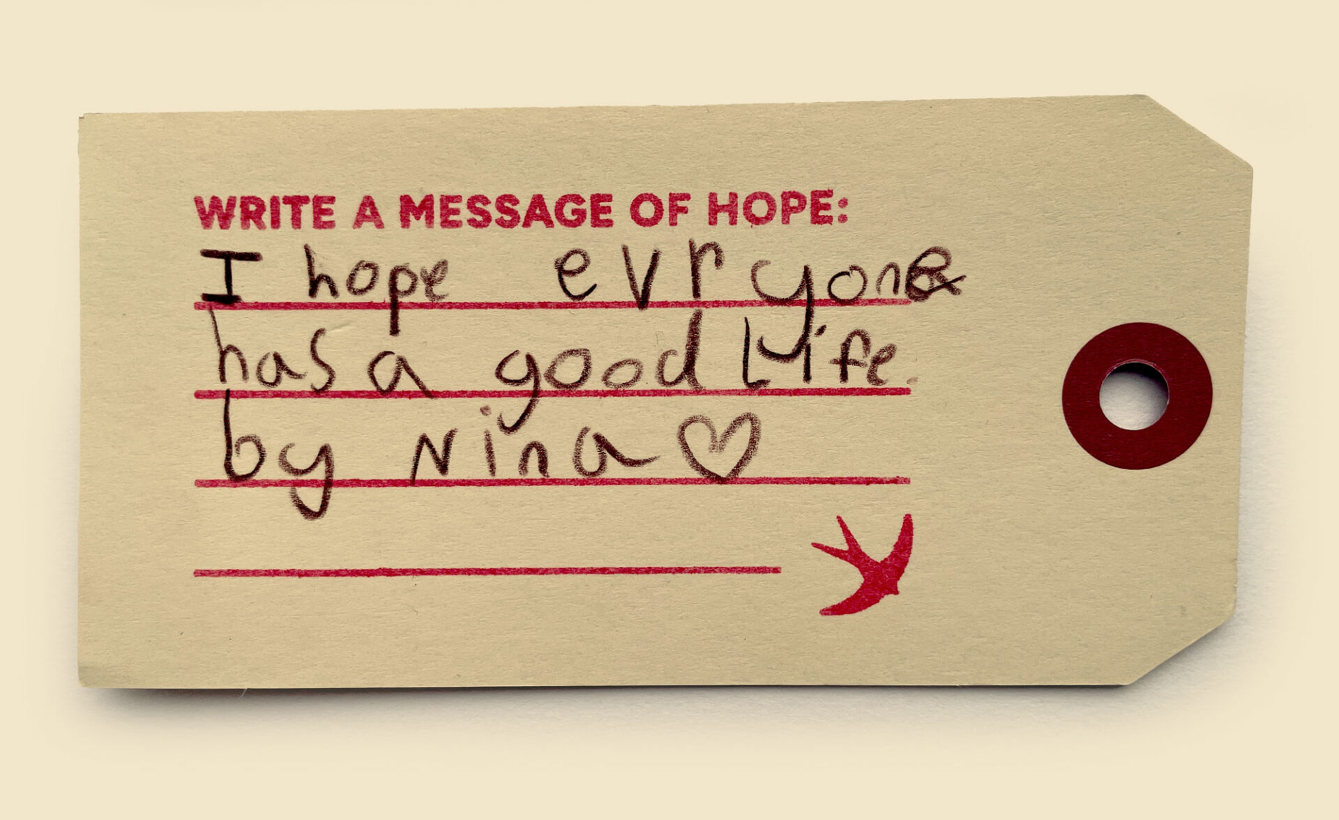 A photo of a luggage label with a handwritten message of hope