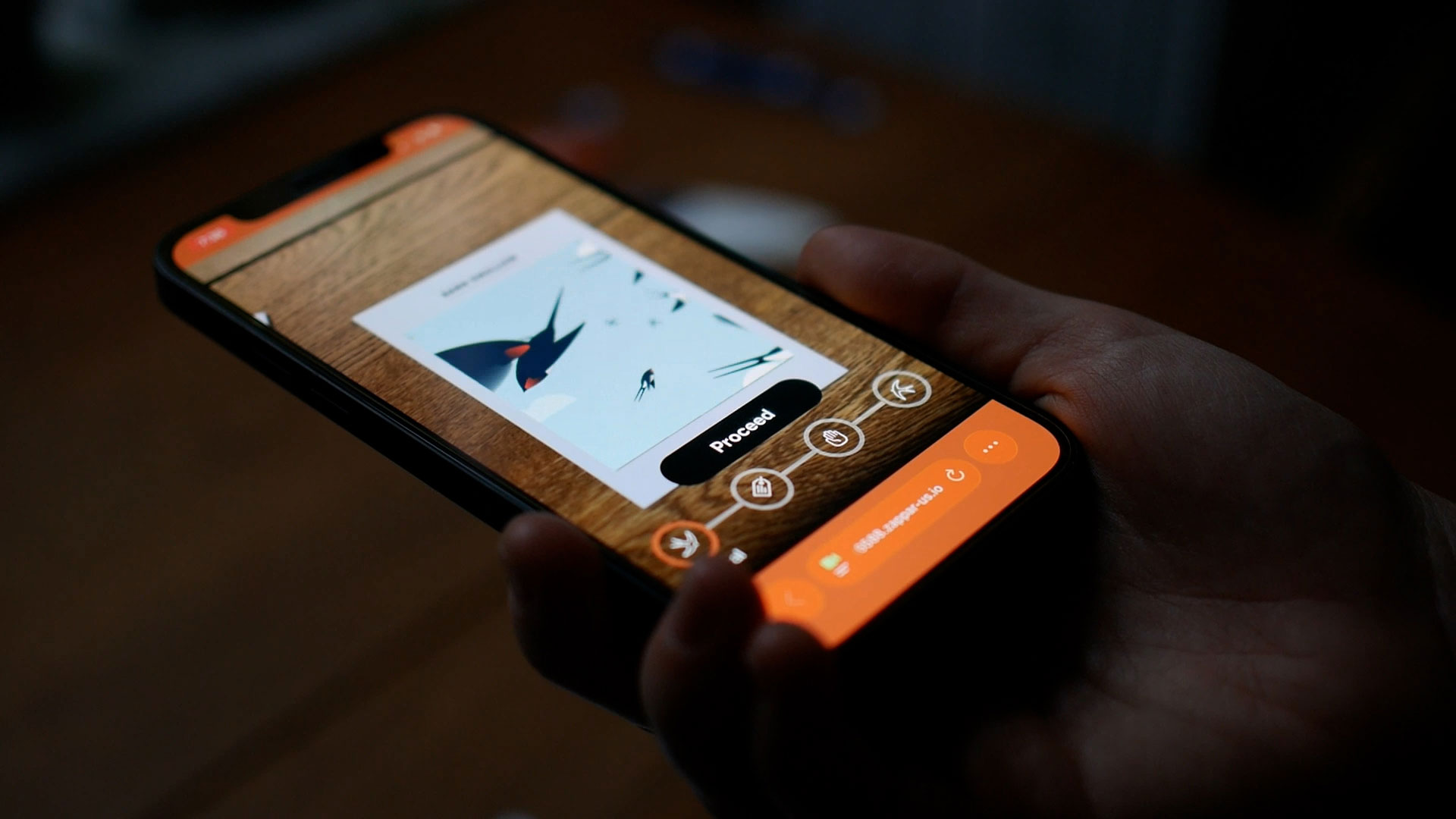 Close-up of a persons hands using a smartphone to explore the Wild Wings of Hope augmented reality barn swallows animated flock in flight.