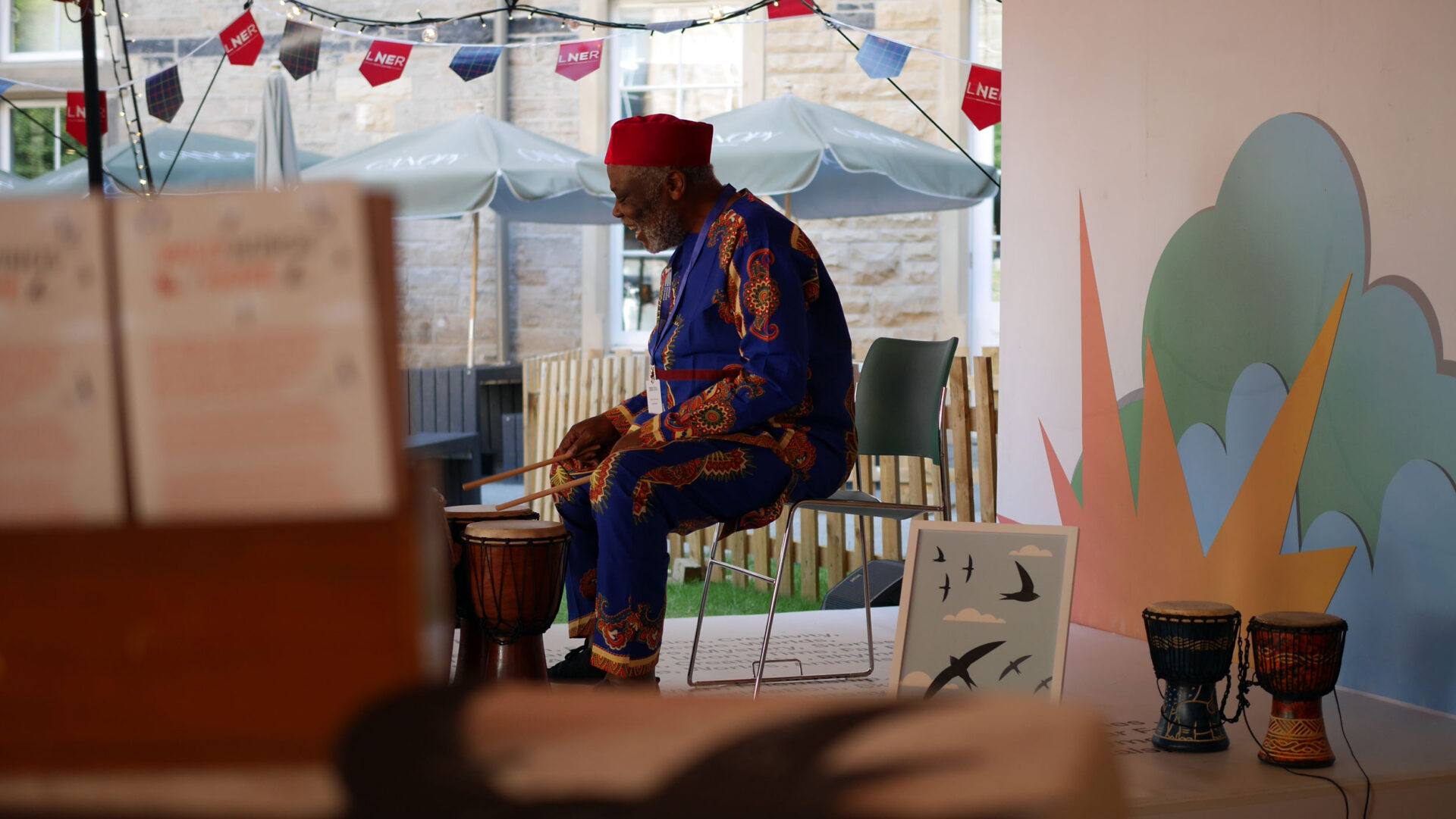 Gift Amu leading children in a participatory song at the Edinburgh International Book Festival.