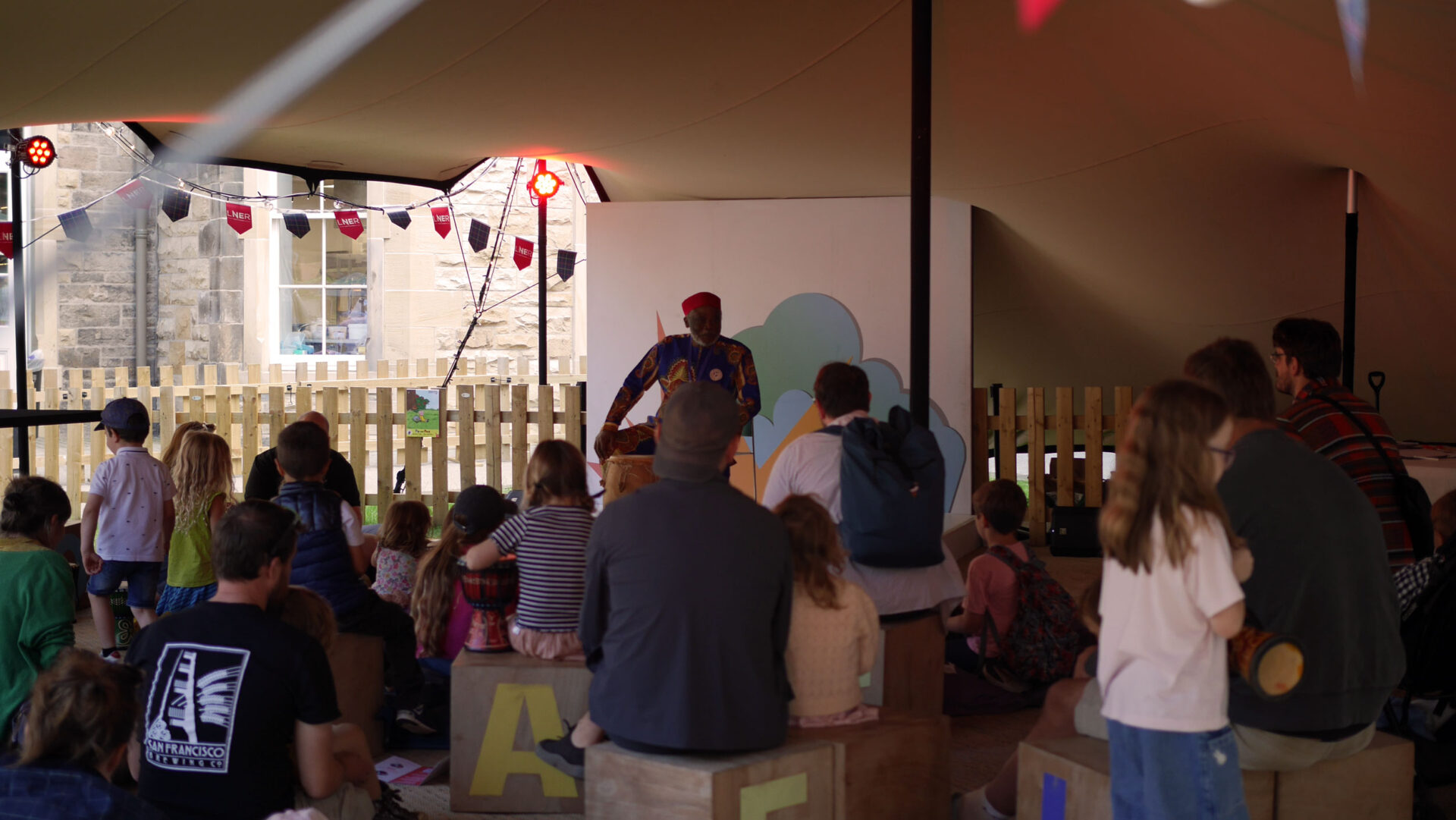 Gift Amu leading children in a participatory song at the Edinburgh International Book Festival.